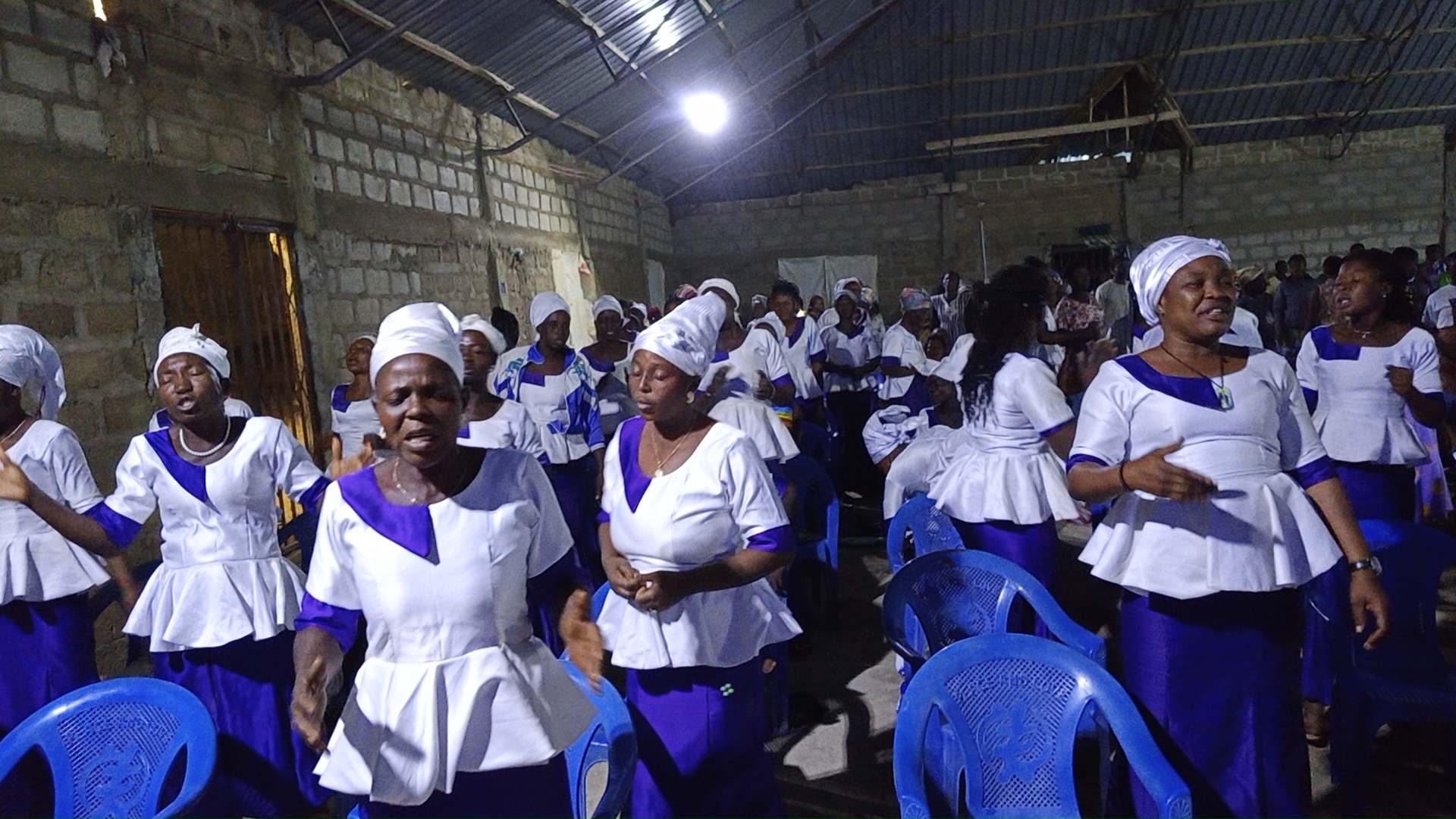 Choir of Christ Rehoboth House Of Grace Church singing in white and purple robes